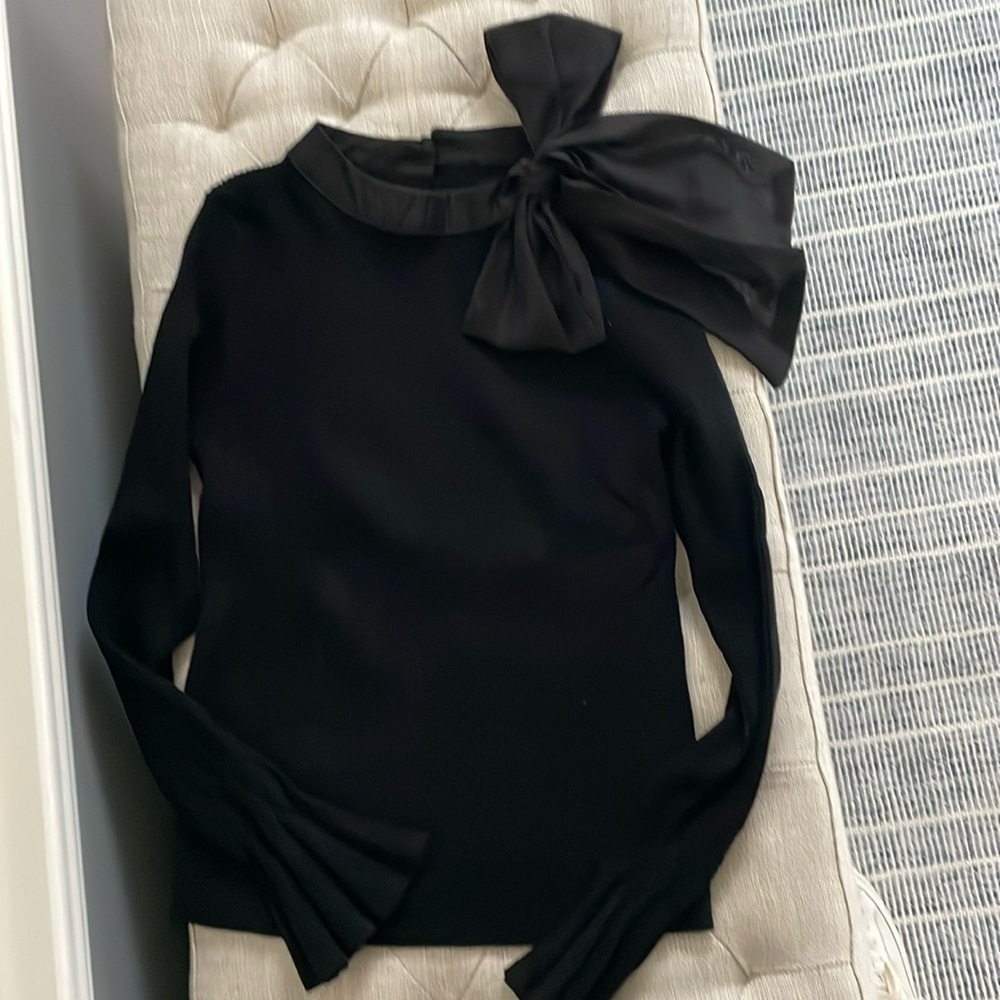 Black sweater with bow covered buttons in back